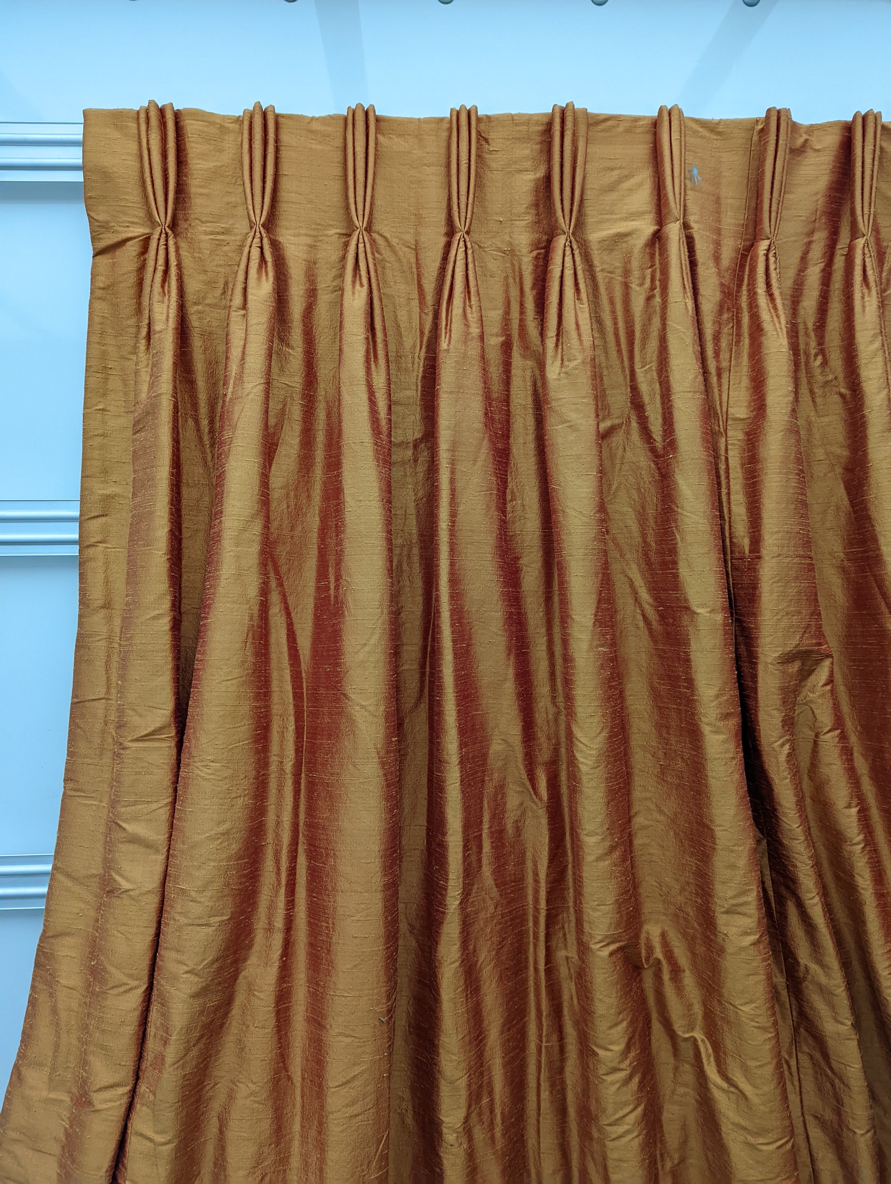 A pair of orange lined curtains. Approximate measurements: Width of top 180cm, Width of bottom 320cm Length 250cm